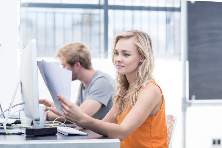 Creative office woman looking at papers